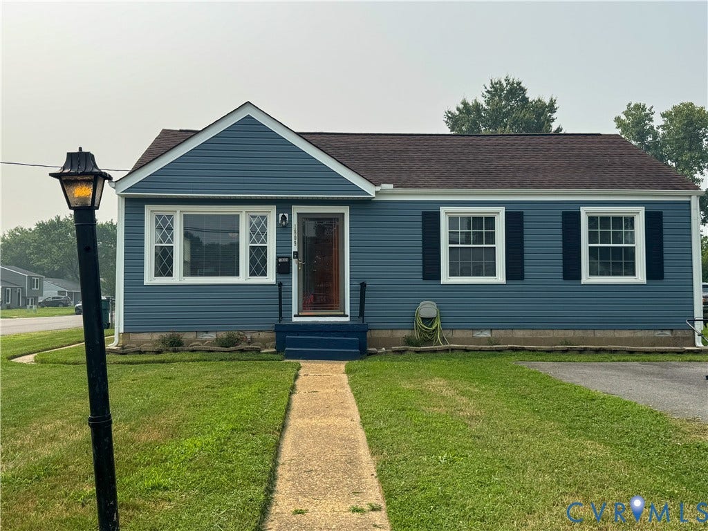 Blue vinyl siding exterior with a brown shingle roof
