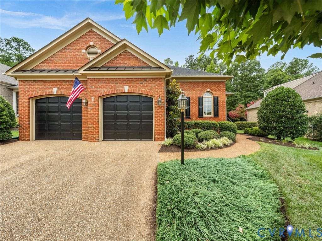 2214 Founders View Lane, Fb Golf Villas, Powhatan, VA 23113 Brick exterior residence featuring two arched garage doors, a gravel driveway, and a landscaped walkway