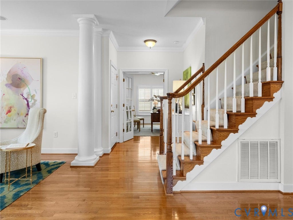 2214 Founders View Lane, Fb Golf Villas, Powhatan, VA 23113 Hardwood flooring extends throughout this entry, featuring a wood staircase with white balusters and a carpet runner