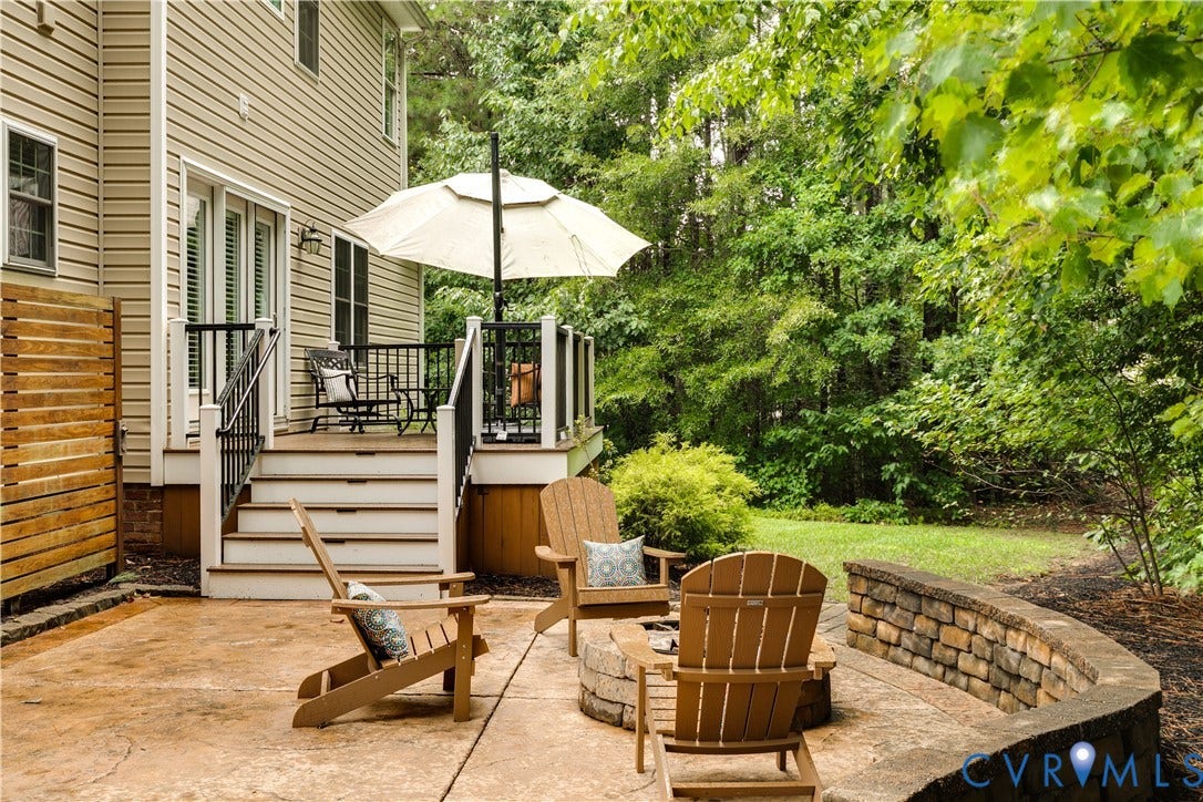 4907 Winding Branch Road, Moseley, VA 23120 Stamped concrete patio featuring a built-in stone fire pit and a curved retaining wall