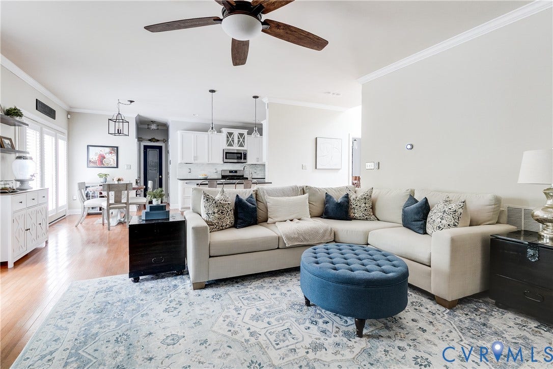 4907 Winding Branch Road, Moseley, VA 23120 Open-concept living space featuring wood flooring, a ceiling fan, and crown molding