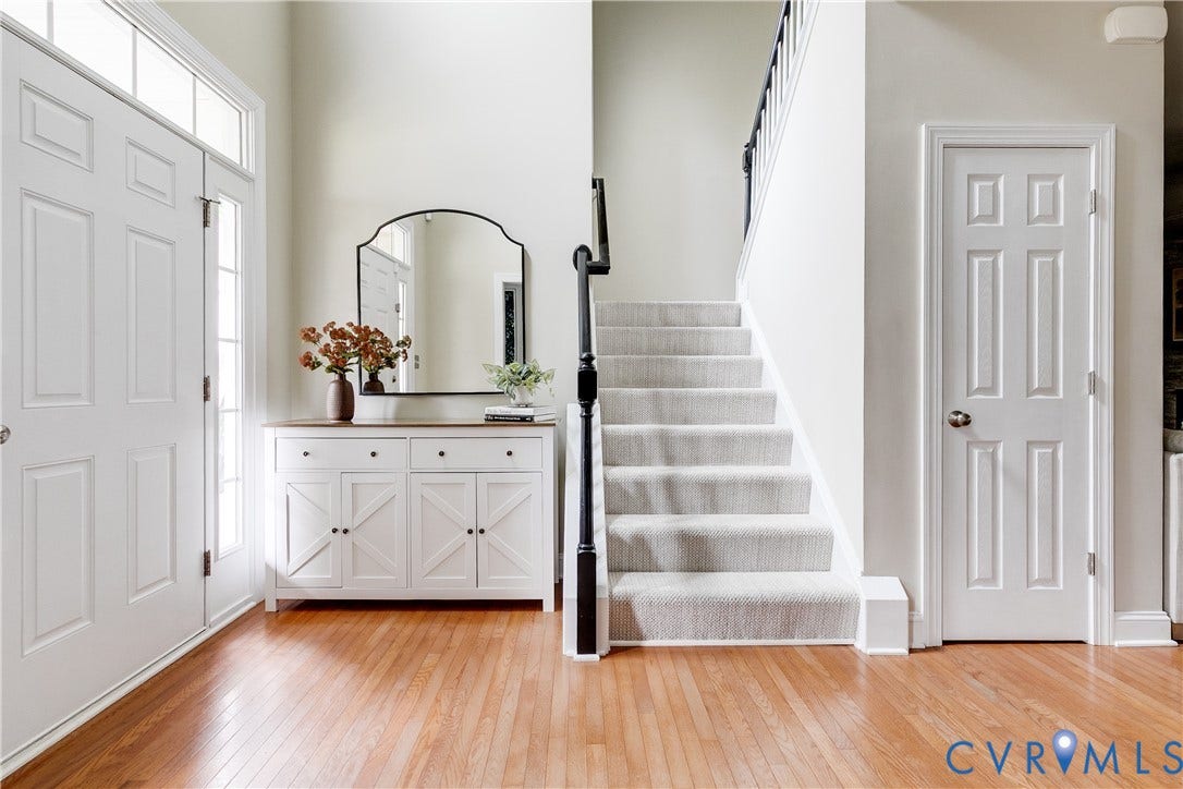 4907 Winding Branch Road, Moseley, VA 23120 Foyer featuring wood-flooring, door with a sidelight and transom, and new carpeted staircase with dark railings