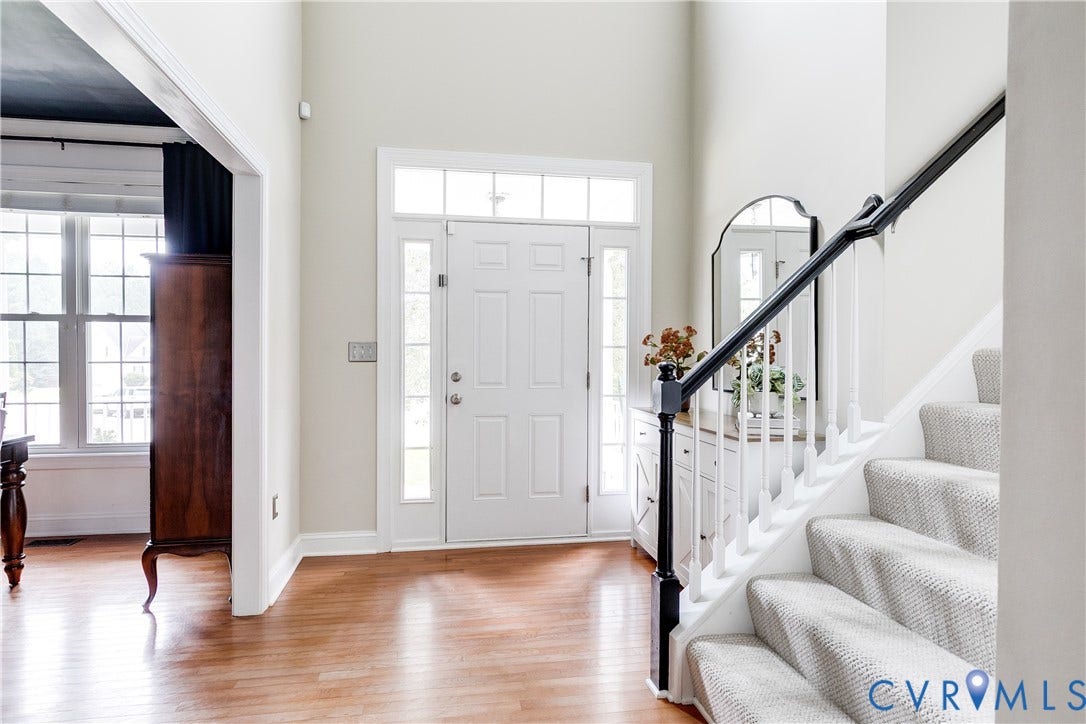 4907 Winding Branch Road, Moseley, VA 23120 Entryway featuring a double-height ceiling, hardwood flooring, a white paneled front door with sidelights and transom