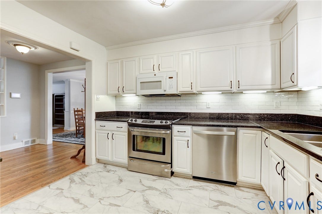 1401 Chowan Road, Henrico, VA 23229 Kitchen featuring white cabinetry with dark hardware, dark countertops, and a white subway tile backsplash