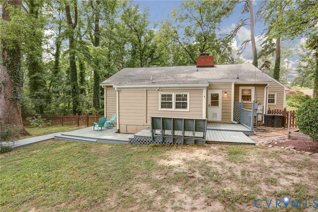 1401 Chowan Road, Henrico, VA 23229 Rear exterior with siding, a gray deck with ramp access, and mature surrounding trees