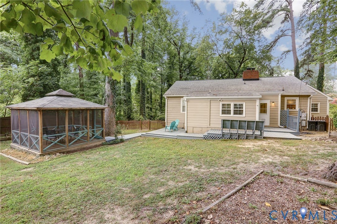 1401 Chowan Road, Henrico, VA 23229 Expansive backyard featuring a screened gazebo, a light-colored exterior, a wooden deck, and mature trees