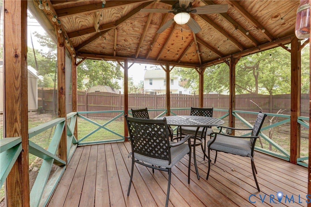 1401 Chowan Road, Henrico, VA 23229 Screened wooden gazebo featuring a slatted wood floor, wood-paneled ceiling, ceiling fan with light fixture, and perimeter string lights