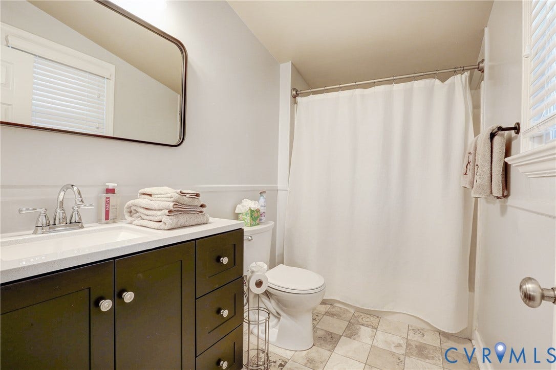 1401 Chowan Road, Henrico, VA 23229 Bathroom featuring a dark wood vanity with a white countertop, chrome faucet, and a rectangular mirror