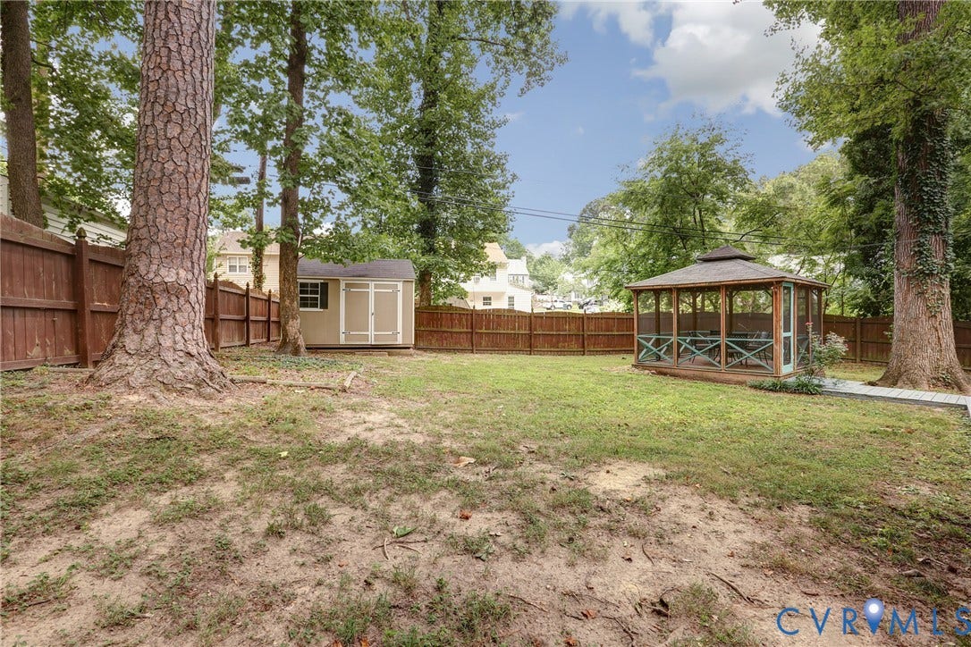 1401 Chowan Road, Henrico, VA 23229 Spacious backyard featuring a screened gazebo, a storage shed, a wood fence, and mature trees