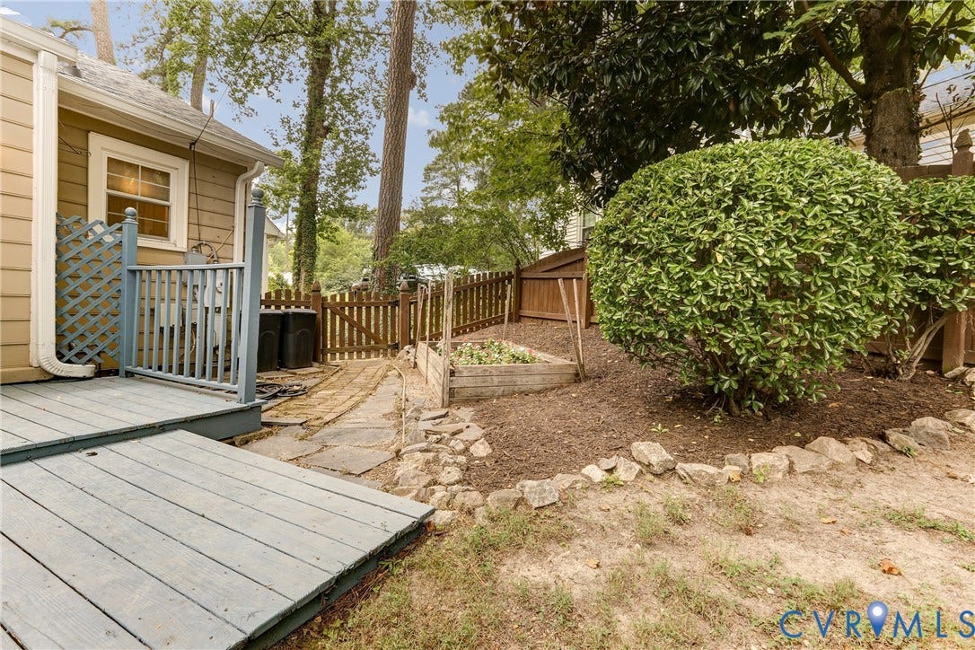 1401 Chowan Road, Henrico, VA 23229 Rear exterior featuring a spacious wooden deck with a lattice privacy screen
