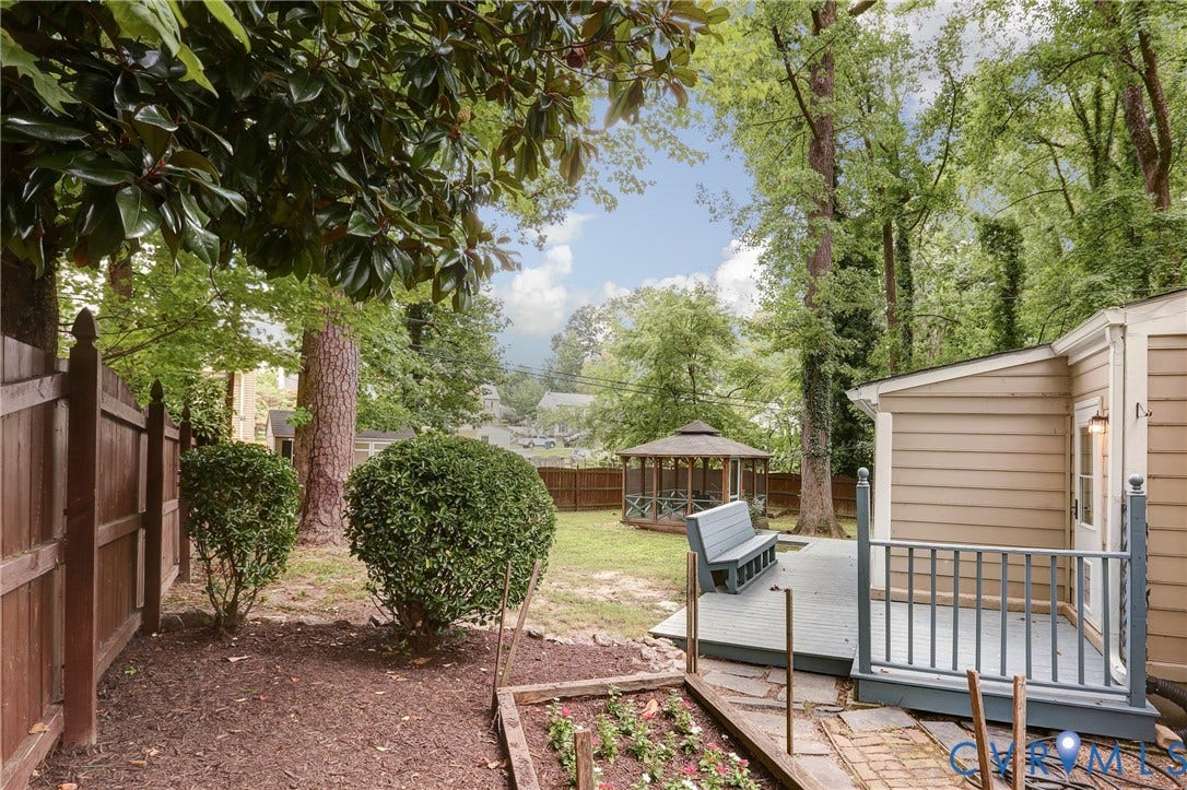 1401 Chowan Road, Henrico, VA 23229 Expansive backyard featuring a gazebo, wood-fencing, mature trees, and a raised deck with railing