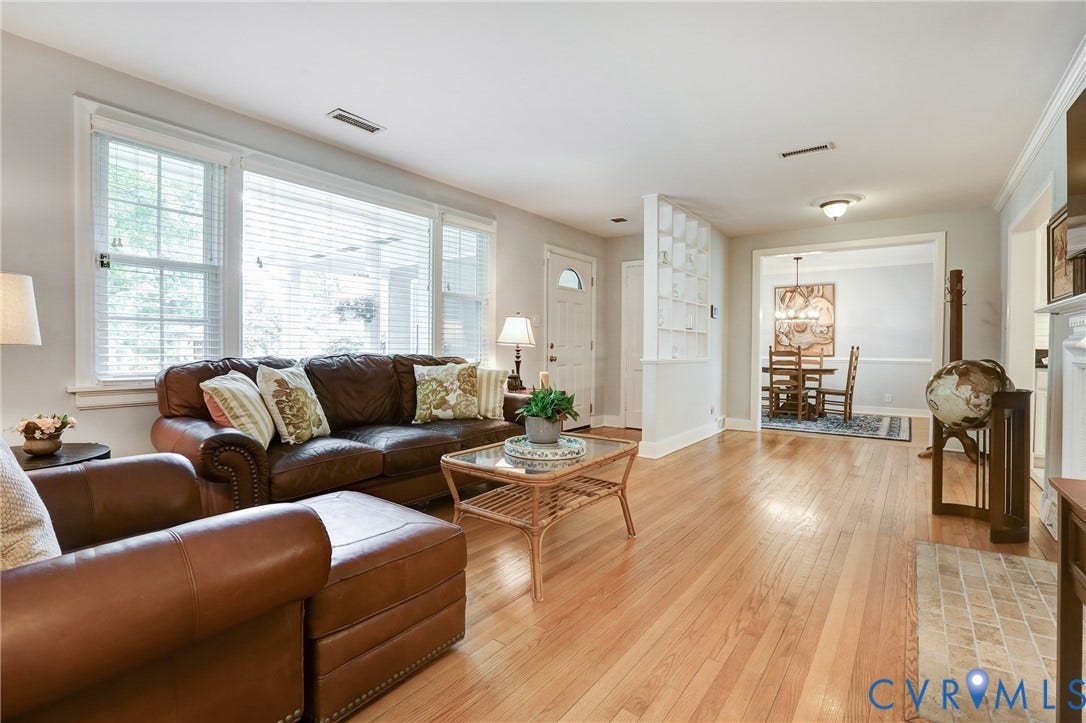 1401 Chowan Road, Henrico, VA 23229 Hardwood flooring extends throughout this living space, featuring abundant natural light from multiple windows