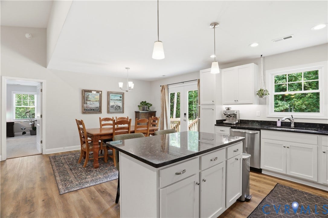 4939 Shannon Hill Road, Kents Store, VA 23084 Bright kitchen featuring white cabinetry, dark stone countertops, stainless steel appliances, and wood-finish flooring