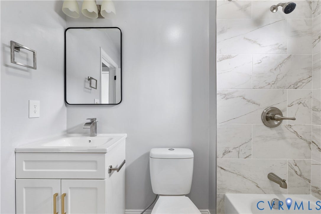 3516 Virginia Street, Woodlawn, Hopewell, VA 23860 White vanity with gold-tone hardware, rectangular undermount sink, and brushed nickel faucet
