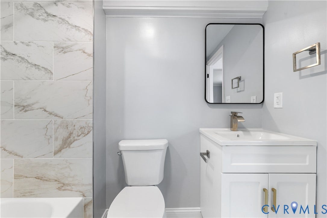 3516 Virginia Street, Woodlawn, Hopewell, VA 23860 White vanity with golden hardware, rectangular undermount sink, and a modern single-handle faucet