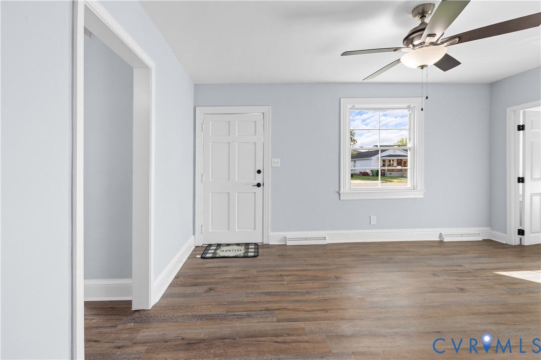 3516 Virginia Street, Woodlawn, Hopewell, VA 23860 Wood-finish flooring, white trim, light wall color, ceiling fan with light, and a paneled door