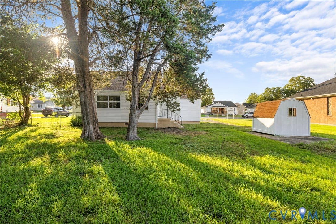 3516 Virginia Street, Woodlawn, Hopewell, VA 23860 Expansive lawn with mature trees and a detached storage shed