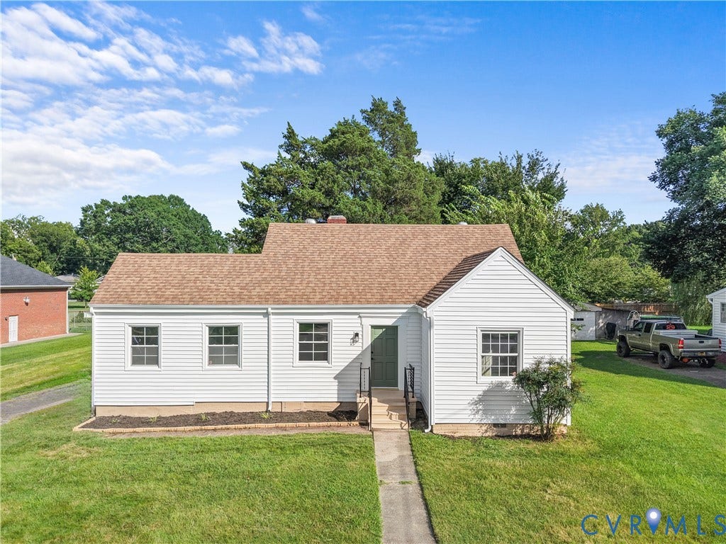 3516 Virginia Street, Woodlawn, Hopewell, VA 23860 White siding exterior with a brown shingle roof, a green front door, and a concrete walkway