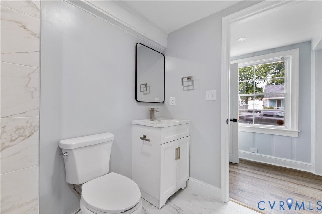3516 Virginia Street, Woodlawn, Hopewell, VA 23860 White vanity with a rectangular sink, modern black-framed mirror, and brushed nickel fixtures