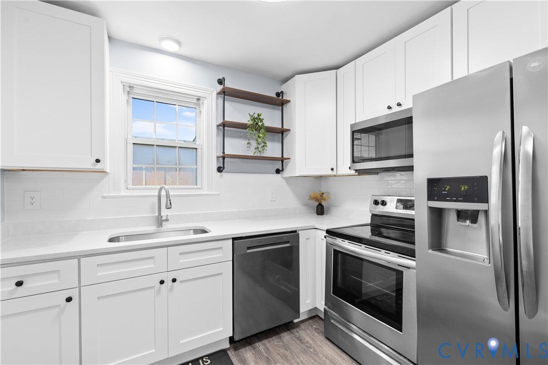 3516 Virginia Street, Woodlawn, Hopewell, VA 23860 White shaker-style cabinetry, stainless steel appliances, light-toned countertops, subway tile backsplash, and wood-finish flooring
