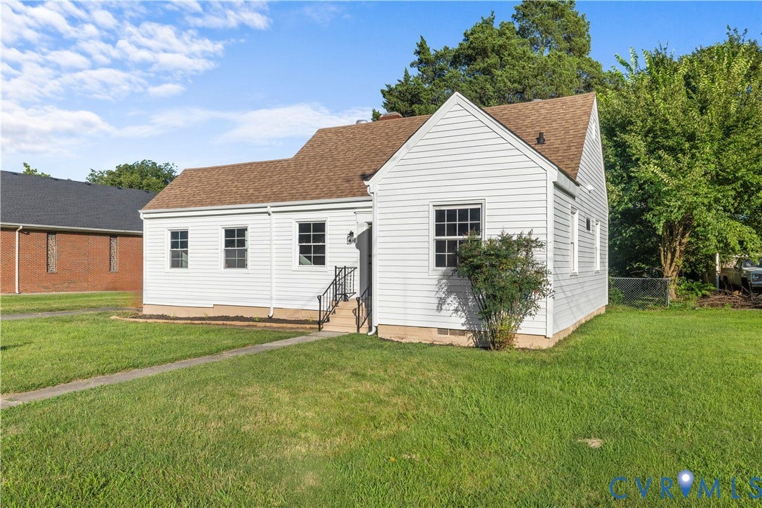 3516 Virginia Street, Woodlawn, Hopewell, VA 23860 White siding exterior with a brown shingle roof, featuring multiple windows, a front entry, and a paved walkway