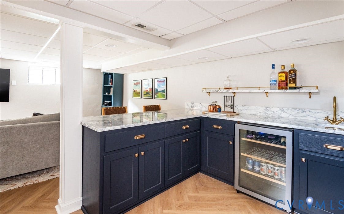 3912 Park Avenue, Malvern Gardens, Richmond, VA 23221 Custom wet bar featuring dark cabinetry, brass hardware, marble-finish countertops, and an integrated beverage refrigerator