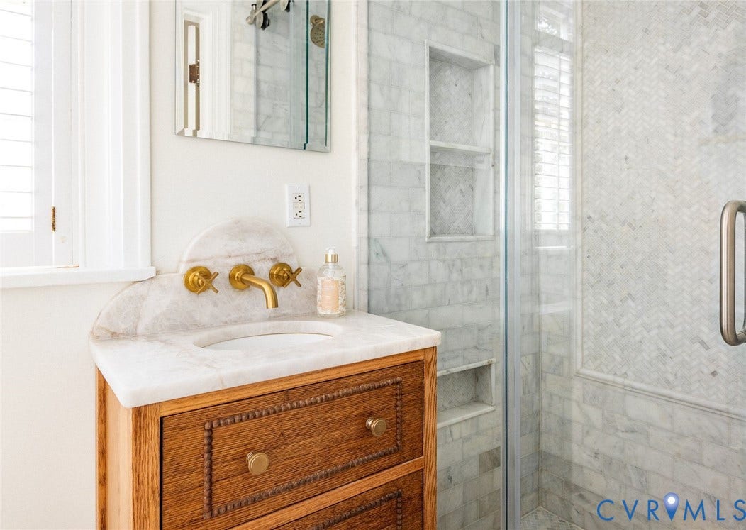 3912 Park Avenue, Malvern Gardens, Richmond, VA 23221 Custom wood vanity with a white stone countertop, brass wall-mounted faucet and custom backsplash, custom tile w/frameless glass surround. Designer finishes