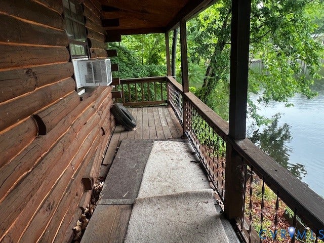 35 Lake Drive, Columbia, VA 23038 Wood-plank exterior porch featuring log siding and a water backdrop