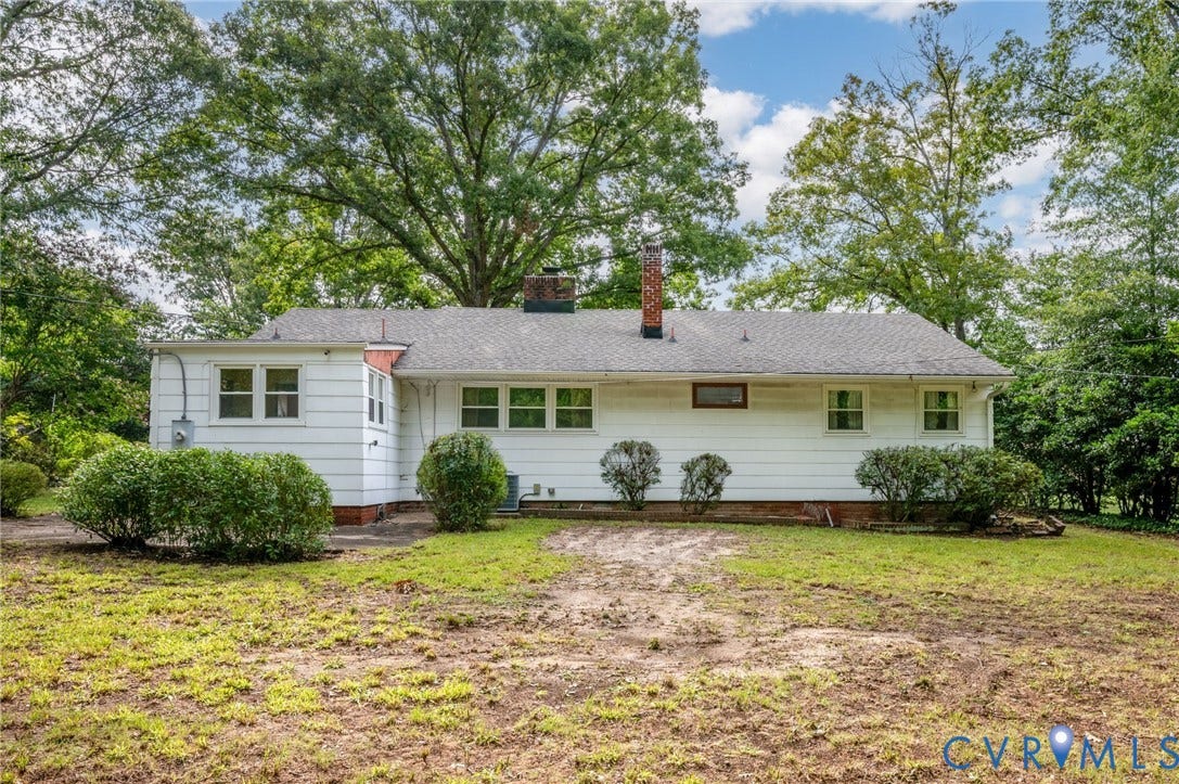 1910 Fon Du Lac Road, Henrico, VA 23229 White siding exterior with a dark shingle roof and a brick chimney