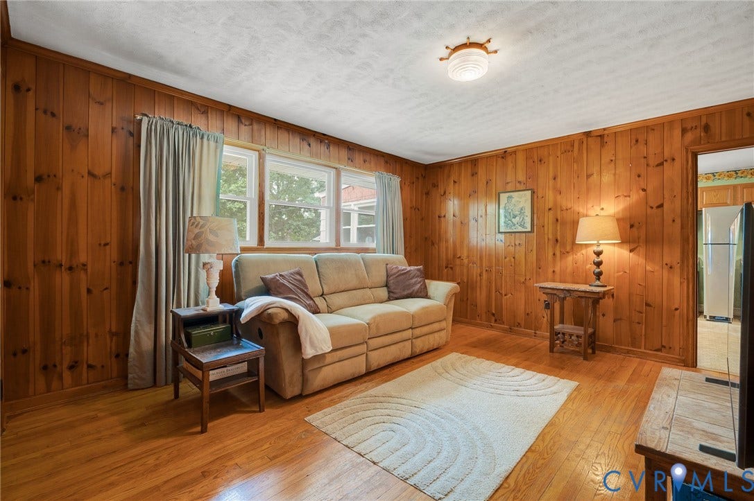 1910 Fon Du Lac Road, Henrico, VA 23229 Wood-paneled room featuring wood-finish flooring, multiple windows, and a flush-mount ceiling light fixture
