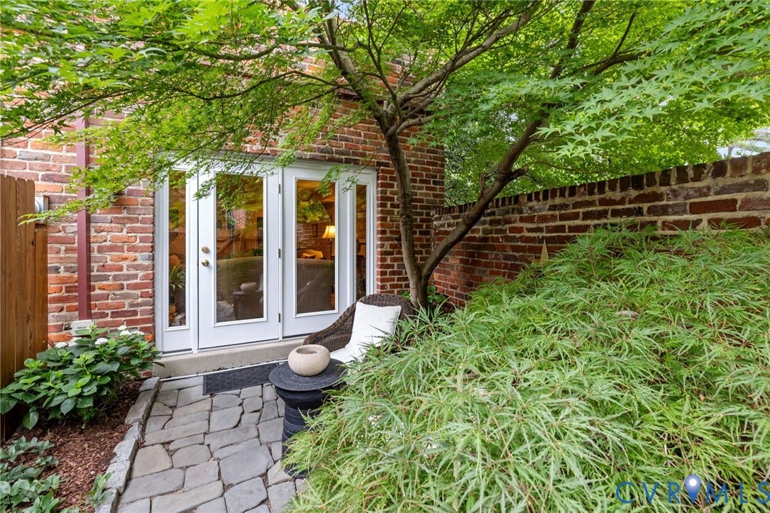 Patio area featuring a stone pathway and mature landscaping