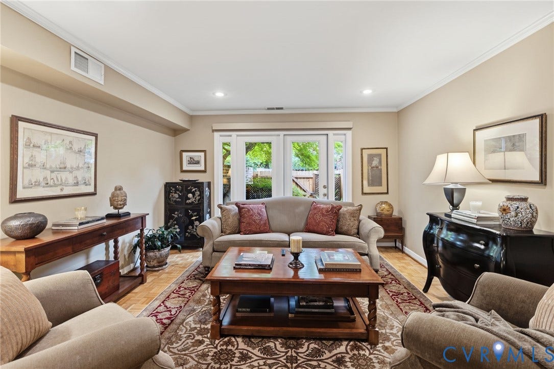 Living area featuring light beige walls, recessed lighting, crown molding, and wood-finish flooring