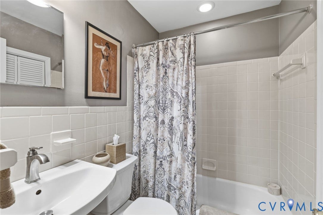 Bathroom with a single vanity, undermount sink, and brushed nickel faucet