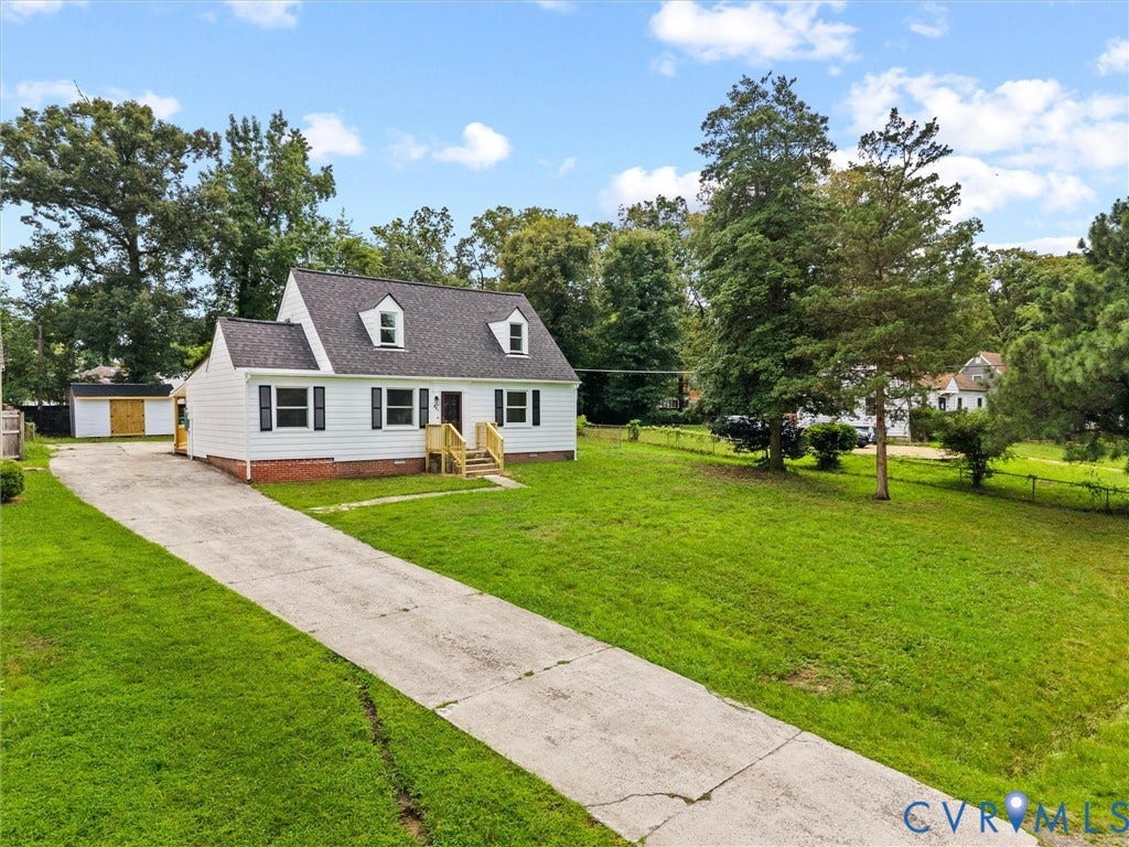 507 Grayson Avenue, Richmond, VA 23222 White siding residence with a dark shingle roof and front dormer windows