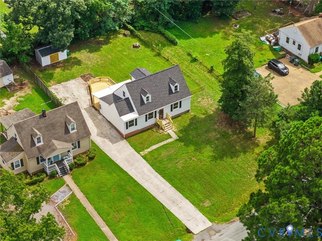 507 Grayson Avenue, Richmond, VA 23222 Cape Cod style home featuring a dark shingle roof, white siding, and black window shutters