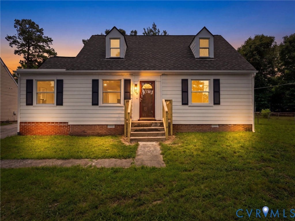 507 Grayson Avenue, Richmond, VA 23222 White siding residence with black shutters, dormer windows, and a dark entry door