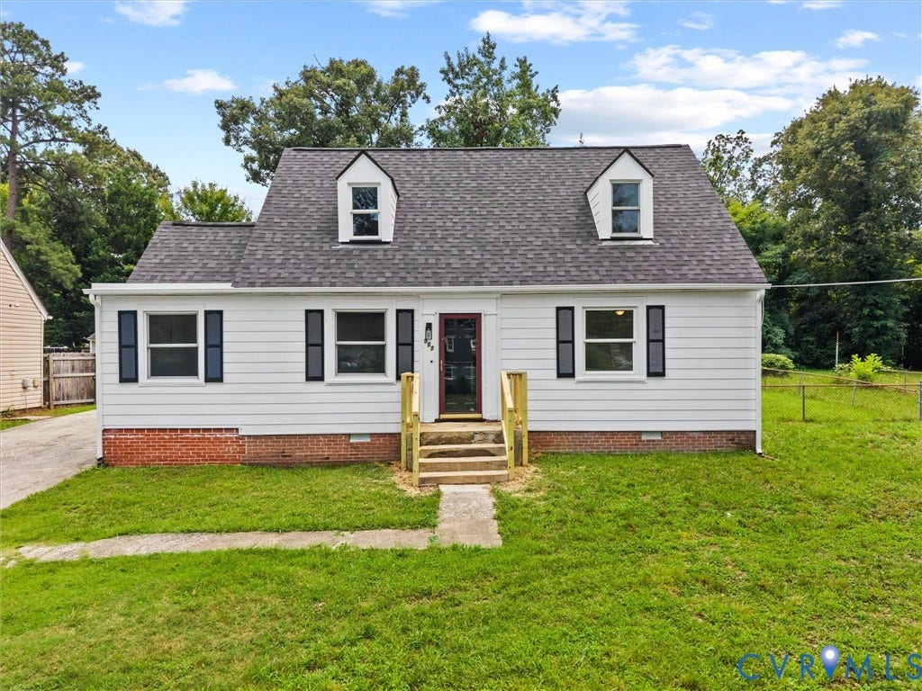 507 Grayson Avenue, Richmond, VA 23222 White siding exterior with a dark shingle roof and two dormer windows