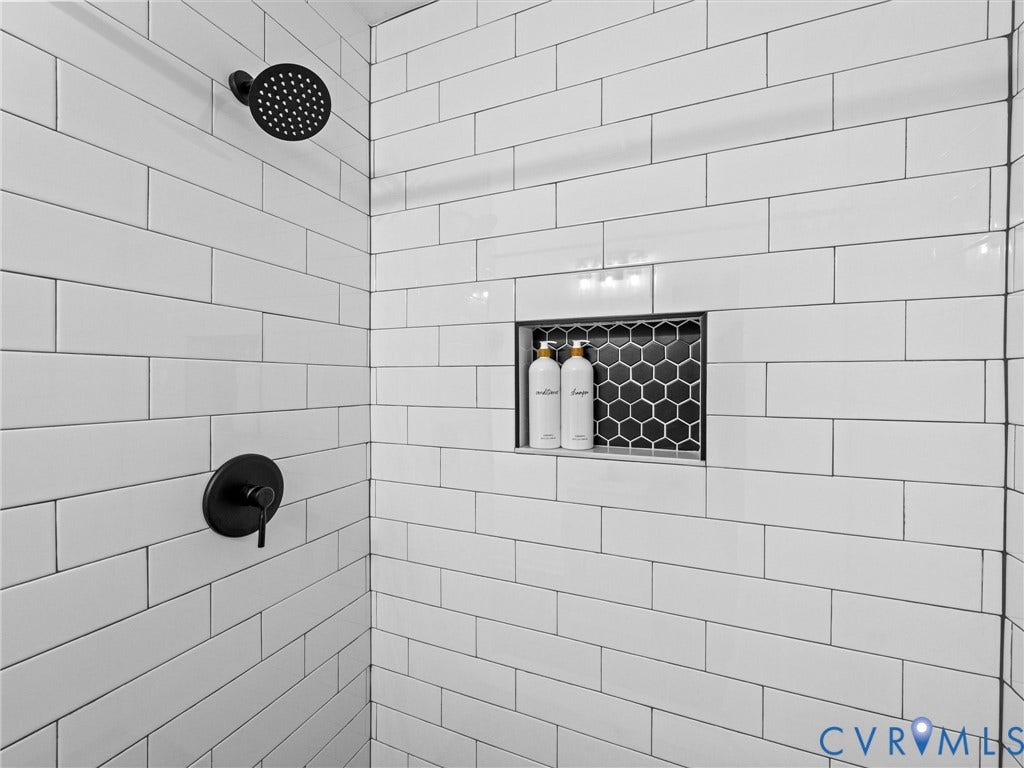 507 Grayson Avenue, Richmond, VA 23222 Shower stall featuring white subway tile surround, matte black shower head, coordinating matte black shower control, and a recessed niche with black hexagonal mosaic tile