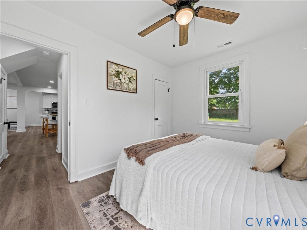 507 Grayson Avenue, Richmond, VA 23222 Bright room featuring a window with exterior views, overhead ceiling fan, wood-finish flooring, and a white interior door