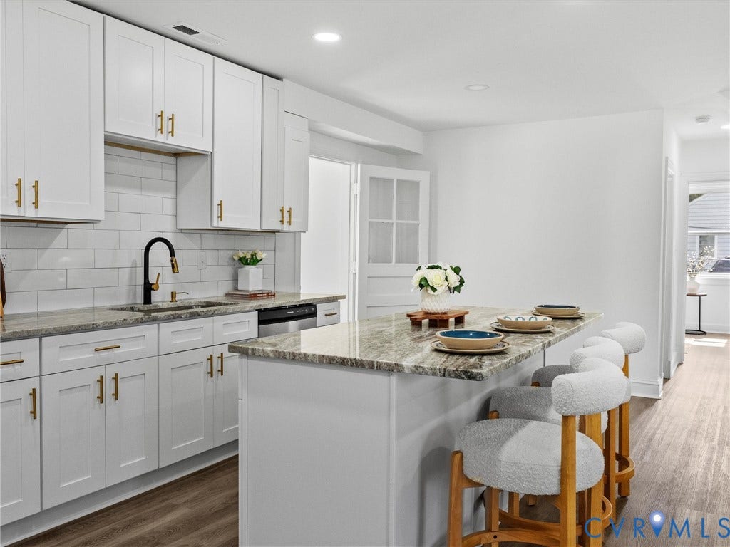 507 Grayson Avenue, Richmond, VA 23222 Contemporary kitchen featuring white cabinetry with gold-tone hardware, granite countertops, subway tile backsplash, and wood-finish flooring