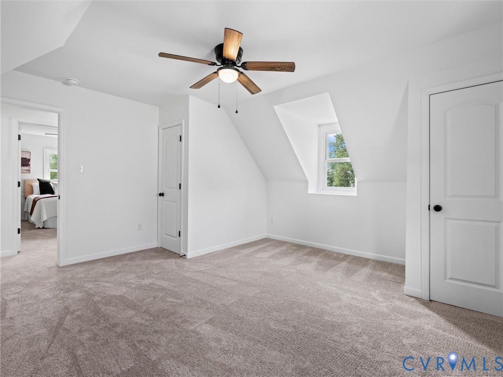507 Grayson Avenue, Richmond, VA 23222 Carpeted room featuring a ceiling fan with wood-finish blades, a single window, and white panel doors