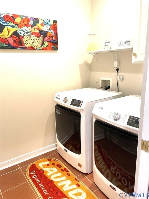 Dedicated laundry area featuring ceramic tile flooring, a built-in wall shelf, and light-toned wall finishes