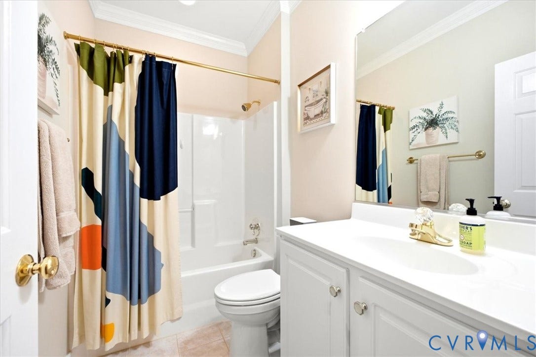 White vanity with integrated sink, white cabinetry, and a gold-finish faucet
