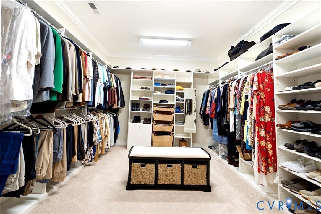 Built-in closet system with extensive hanging rods and integrated shelving
