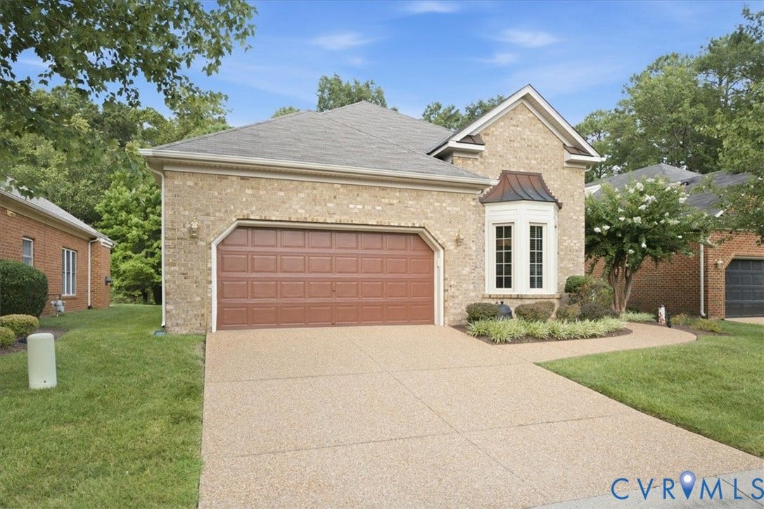 Brick exterior with a prominent bay window featuring a copper-finish accent