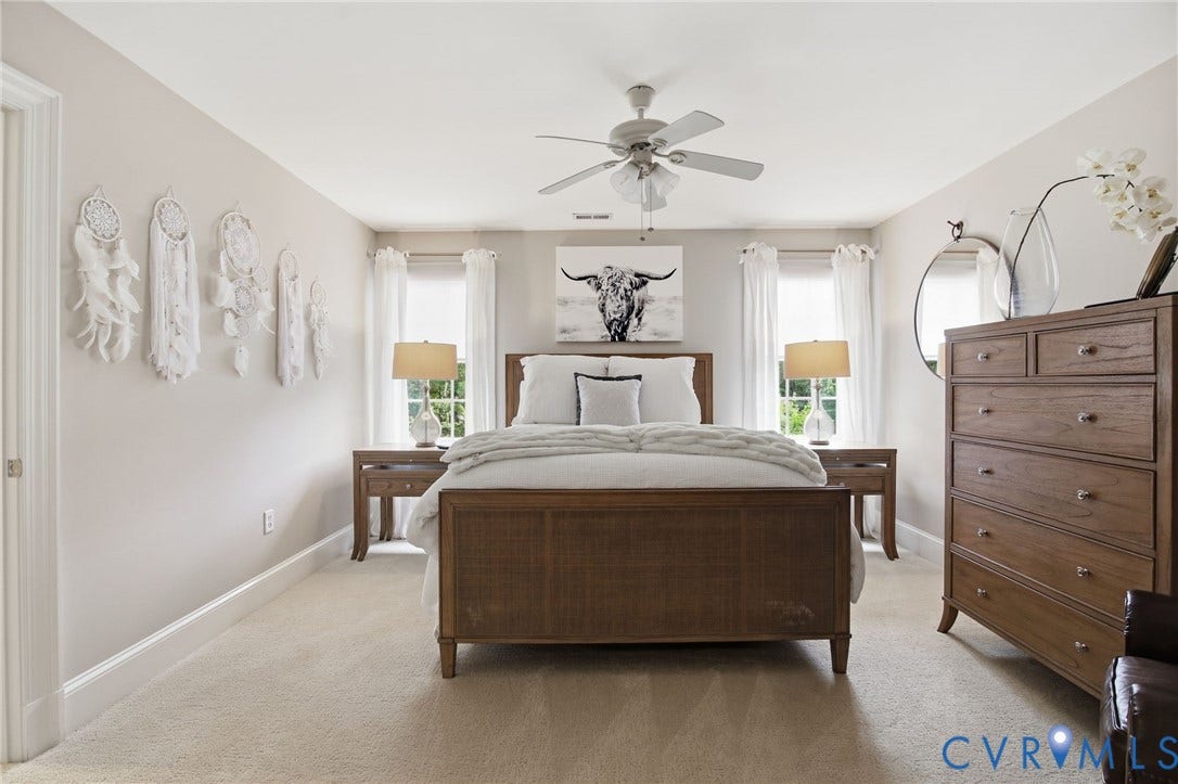 435 Shadow Creek Lane, Manakin Sabot, VA 23103 Spacious bedroom featuring light neutral wall paint, soft carpet flooring, a ceiling fan, and two windows providing natural light