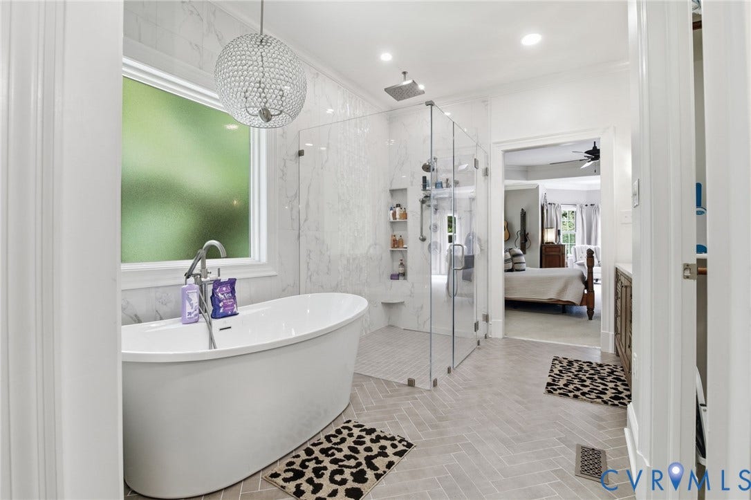 435 Shadow Creek Lane, Manakin Sabot, VA 23103 Freestanding soaking tub with floor-mounted faucet, complemented by a crystal sphere chandelier