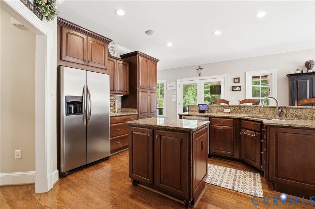 435 Shadow Creek Lane, Manakin Sabot, VA 23103 Kitchen featuring wood-finish flooring, dark wood cabinetry, granite countertops, and a stainless steel side-by-side refrigerator