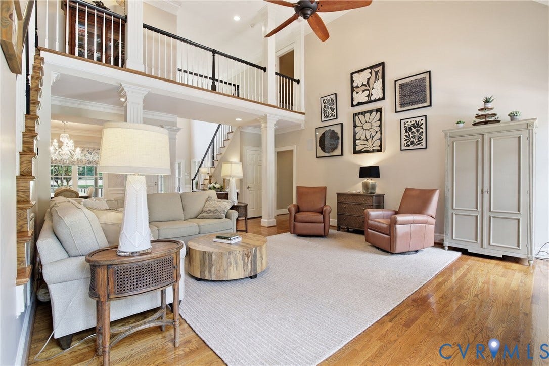 435 Shadow Creek Lane, Manakin Sabot, VA 23103 Two-story great room featuring a vaulted ceiling with a wood-bladed ceiling fan, hardwood flooring, and an open second-story landing with black metal balusters