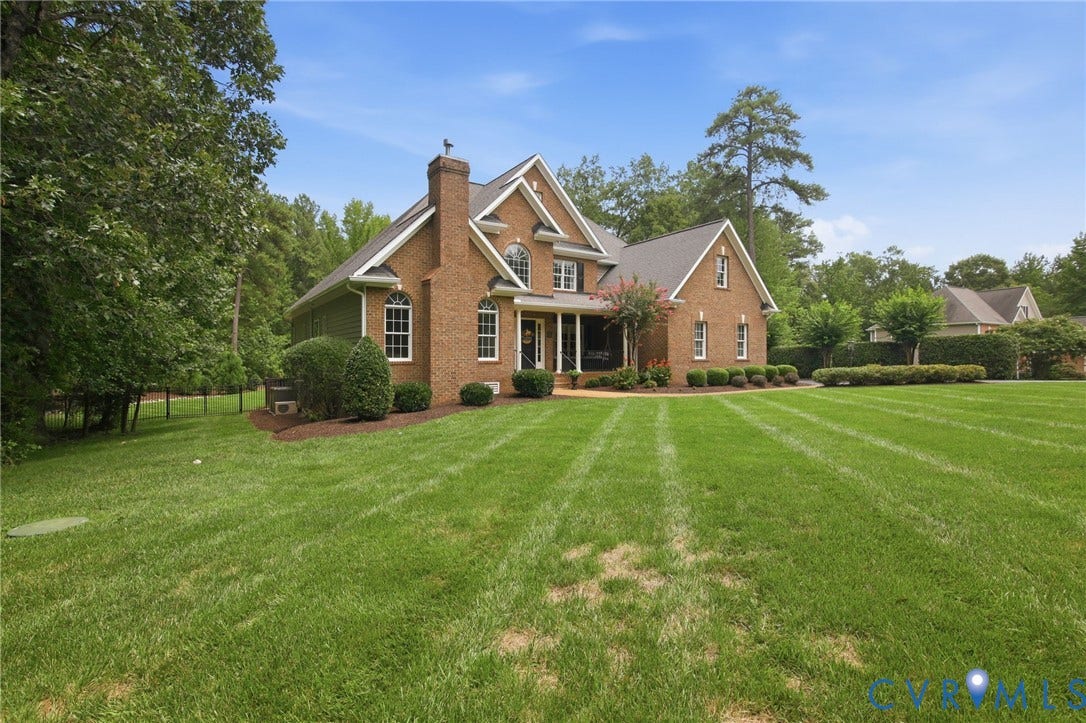 435 Shadow Creek Lane, Manakin Sabot, VA 23103 Brick exterior featuring gabled rooflines, a covered porch, an arched window, and a prominent chimney